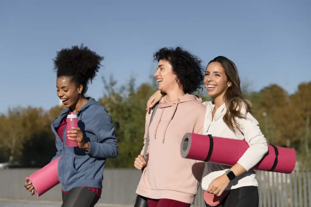 medium shot women with yoga mats.