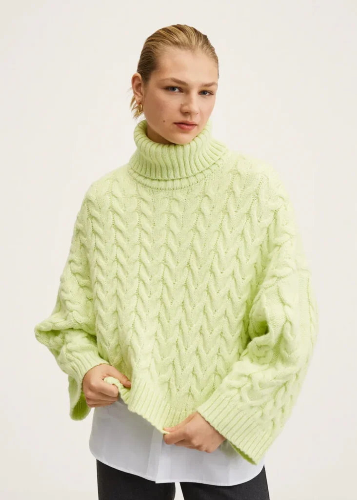 blonde model wearing an oversized lime green turtle-neck jumper