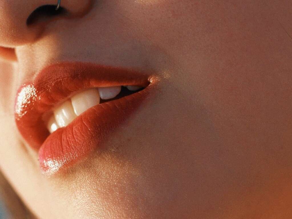 Close up of a woman's lips with red lipstick on