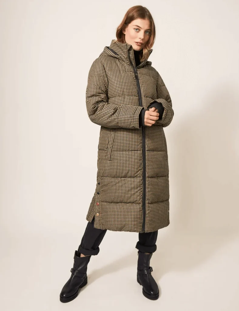 Model poses wearing houndstooth longline quilted coat