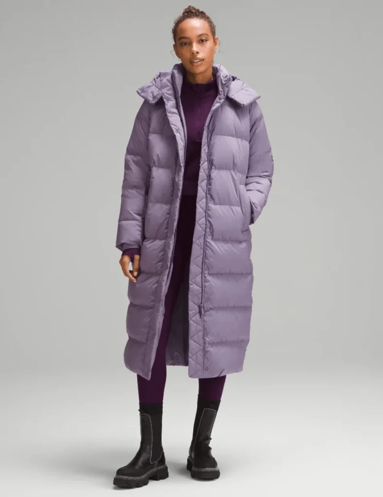 Model poses wearing purple longline puffer coat