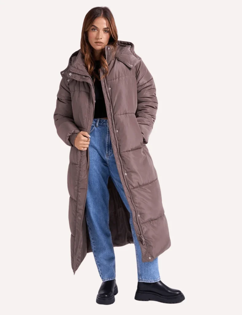 Model wears long brown duvet puffer coat