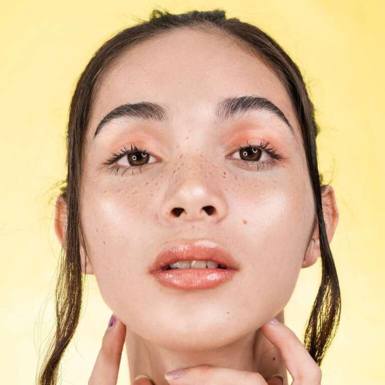 A young woman with moisturised skin. How to get dewy skin