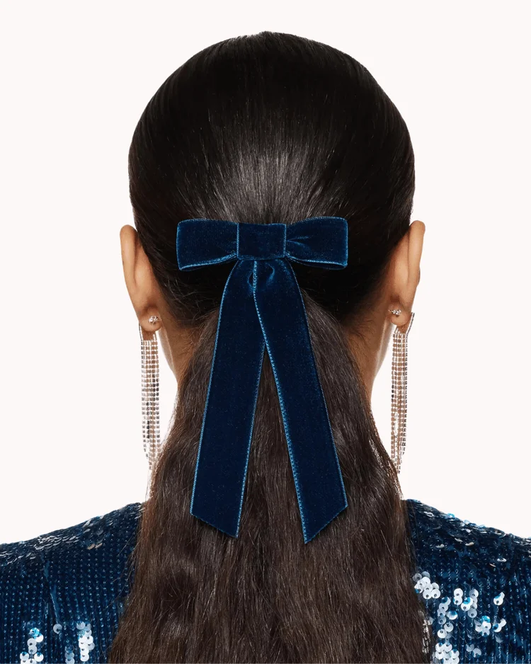 Back view of woman wearing navy blue velvet hair tie