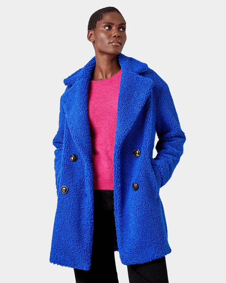 Model woman wears royal blue longline teddy coat