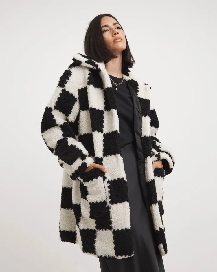 model woman wears monochromatic checkerboard teddy coat