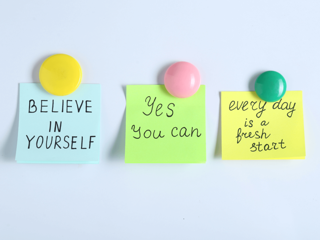 three sticky notes with three positive affirmations for good luck