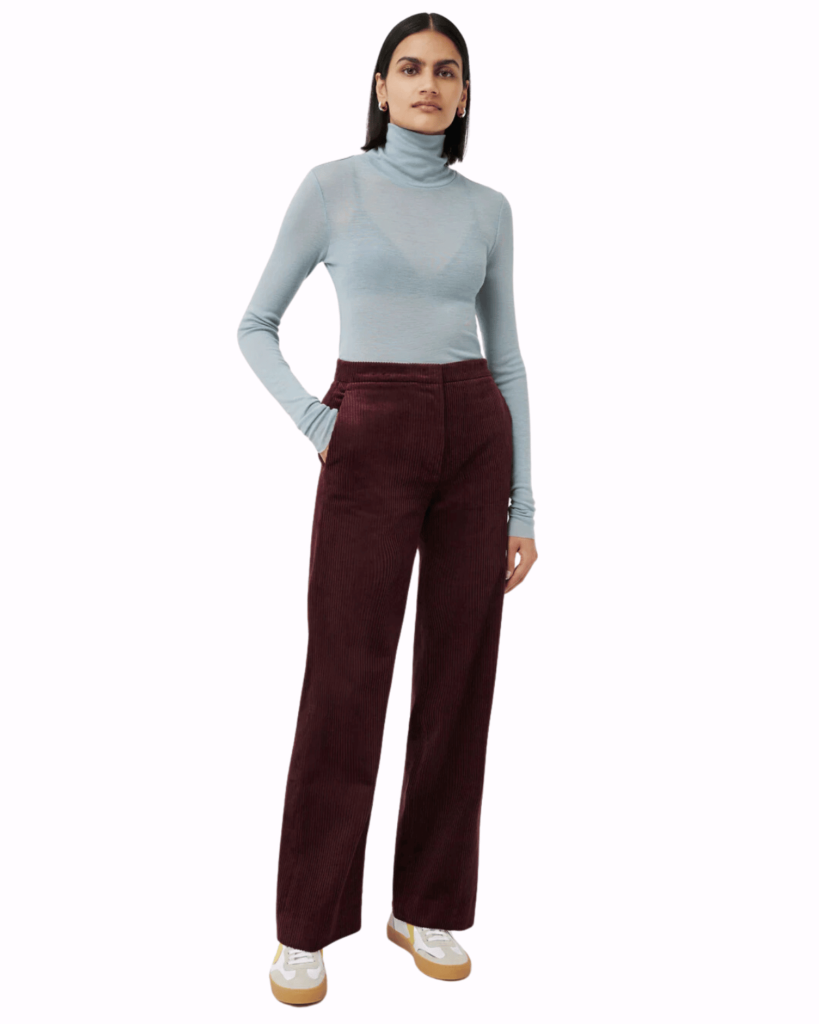 Model wear purple corduroy trousers with blue roll neck top