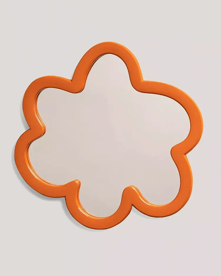 orange cloud shaped mirror on a grey background