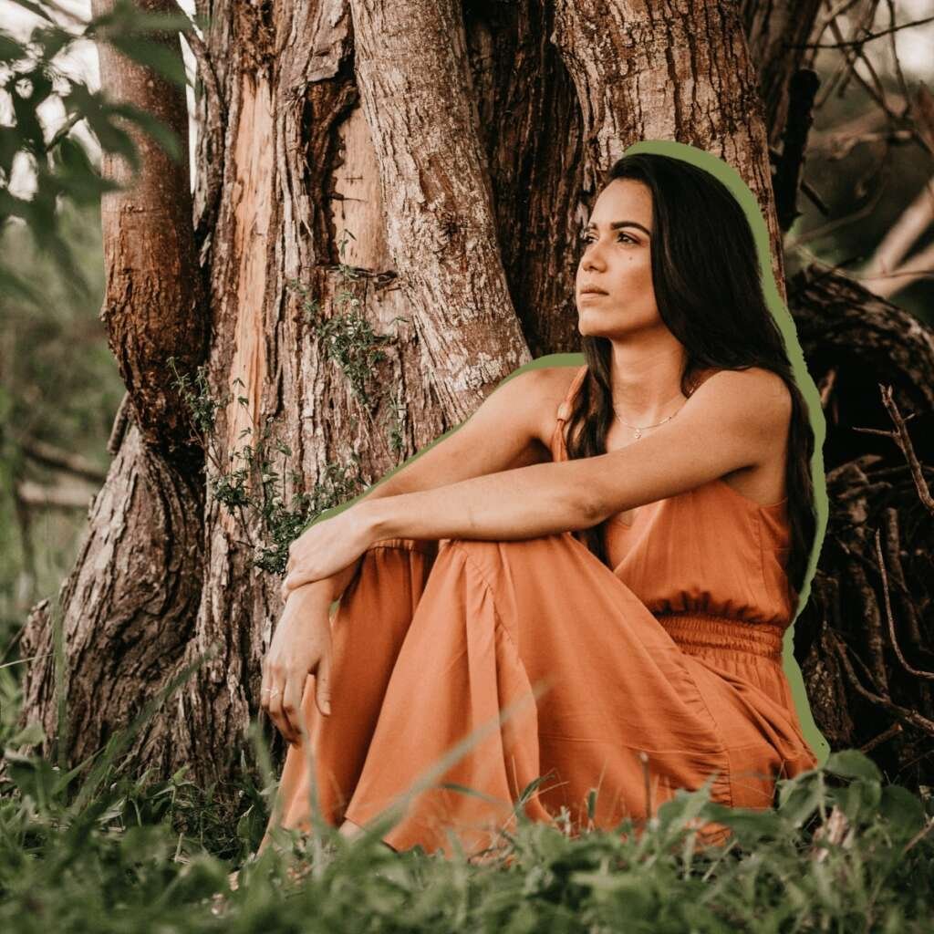 Contemplative ethnic woman admiring nature in countryside