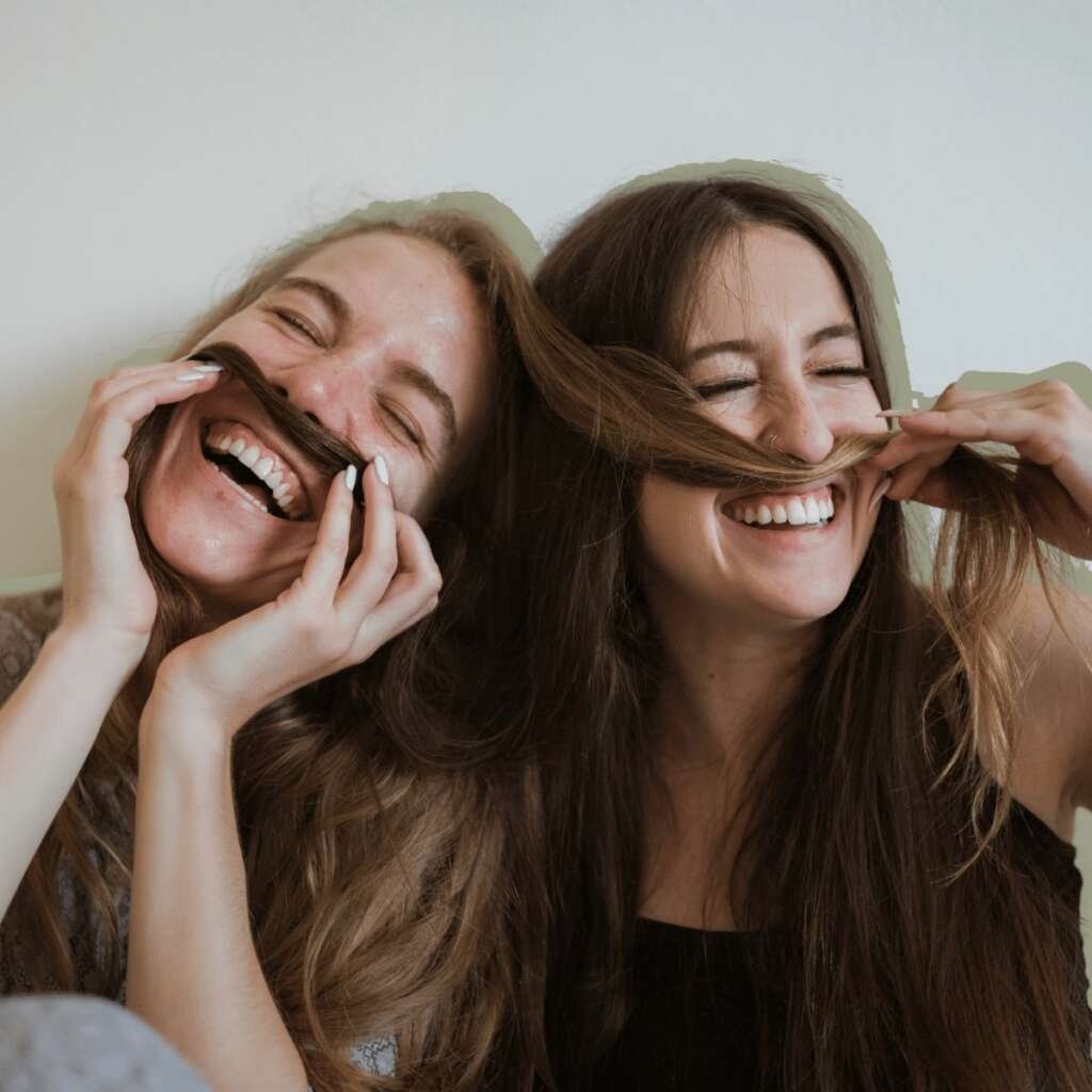 Two female friends Being Silly with their+friends