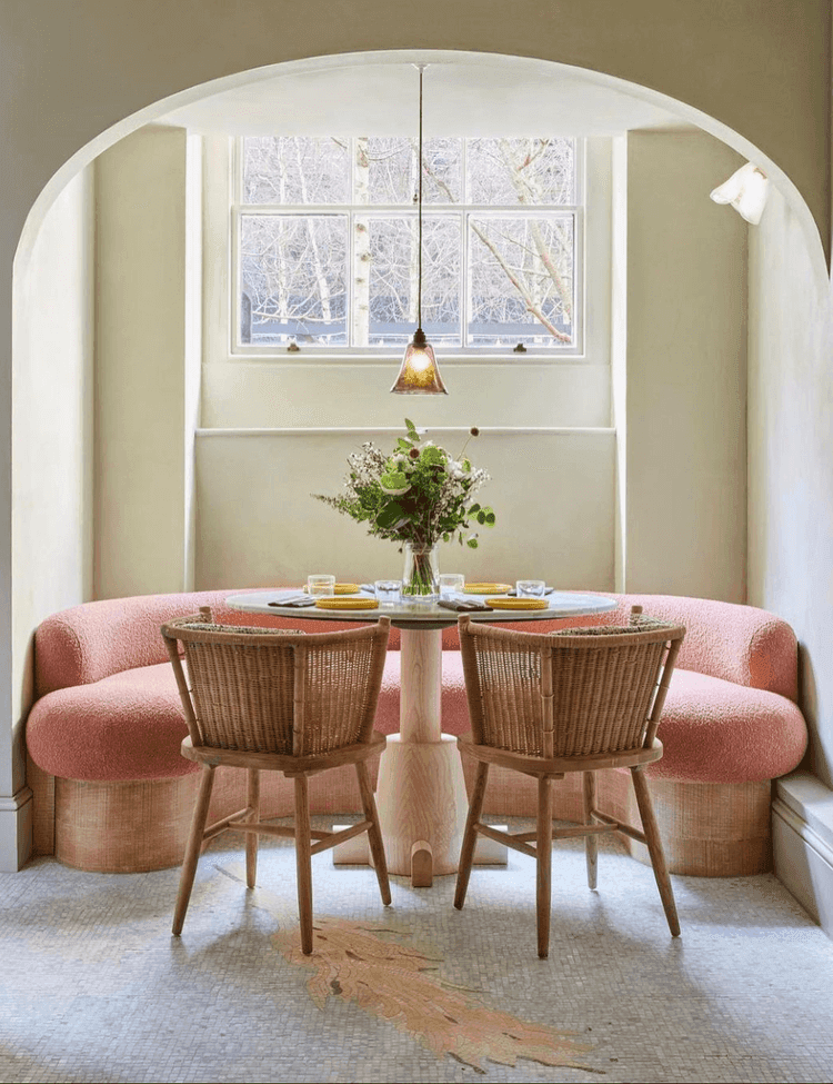 luxurious breakfast nook with a rounded pink boucle sofa