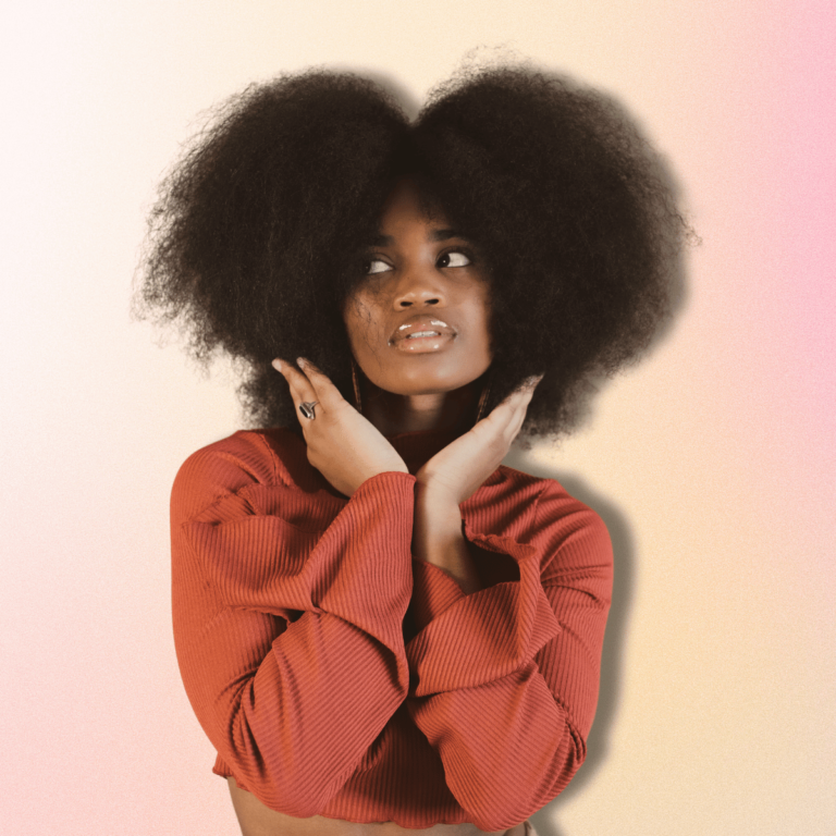 Woman with afro facing the camera and wearing a red top