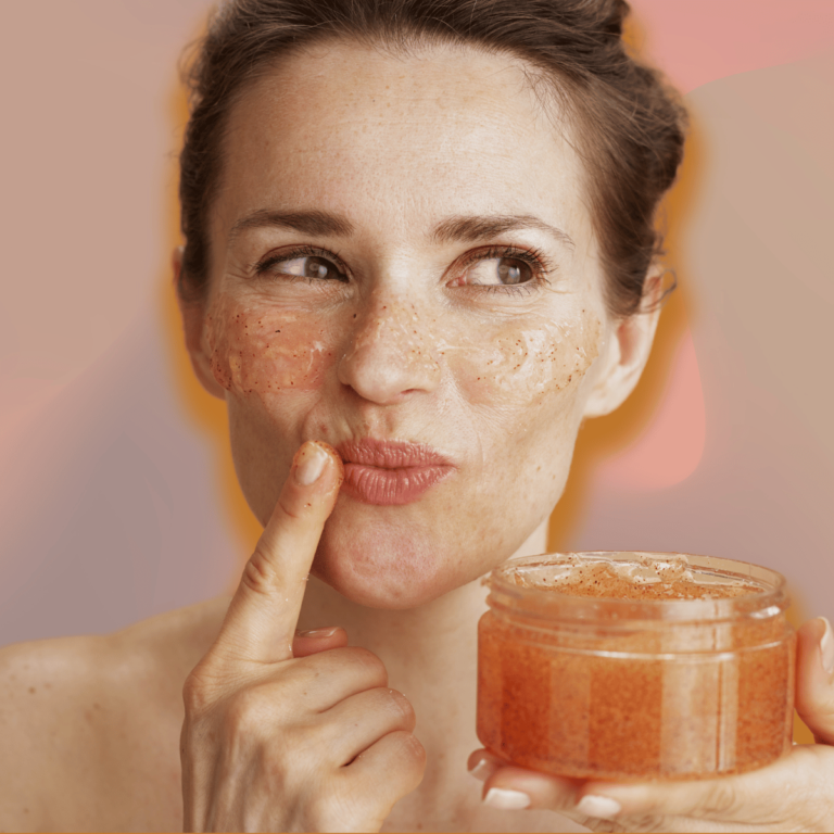 woman smiling applying a scrub to her face