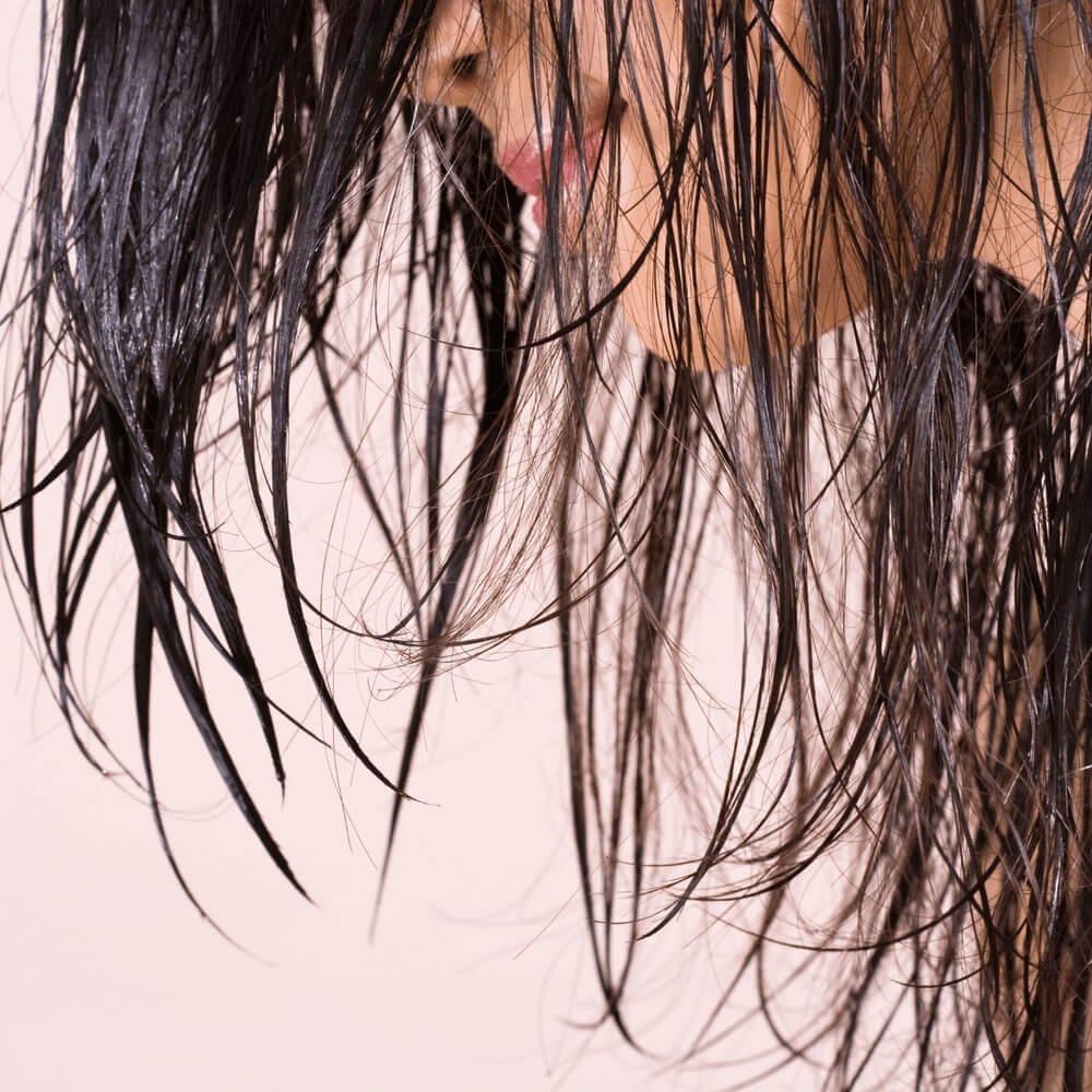 Cropped woman with wet hair.