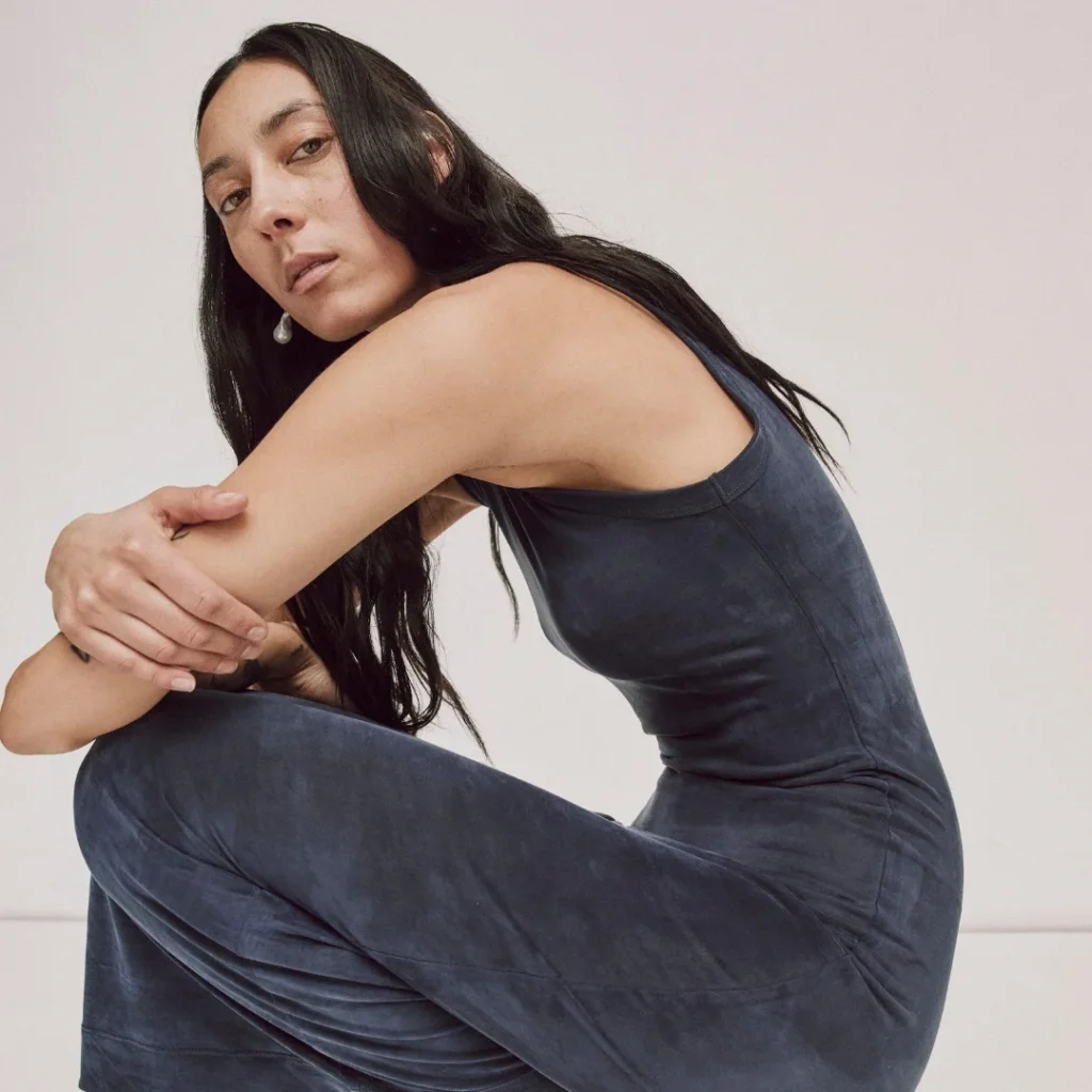 Model wearing a sleeveless textured navy dress