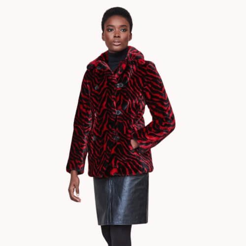 Model wearing a red and black zebra print faux fur coat with a faux fur skirt. Vegan Luxury Brands