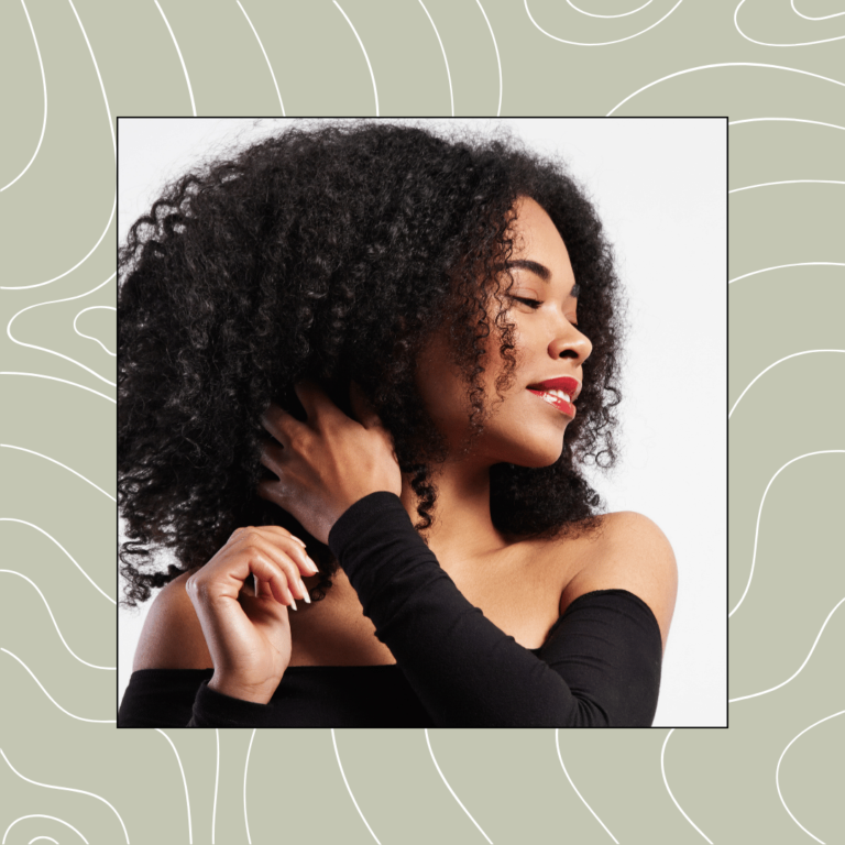 Beautiful woman touching her curly hair. Does Low Porosity Hair Need Protein?