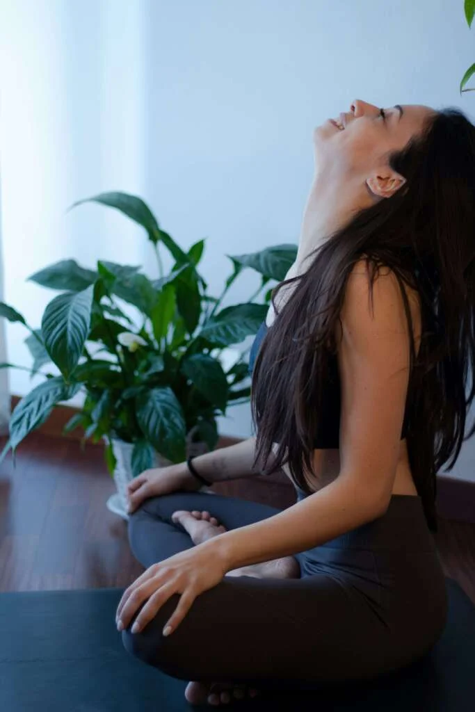 Woman smiling doing yoga at home. 