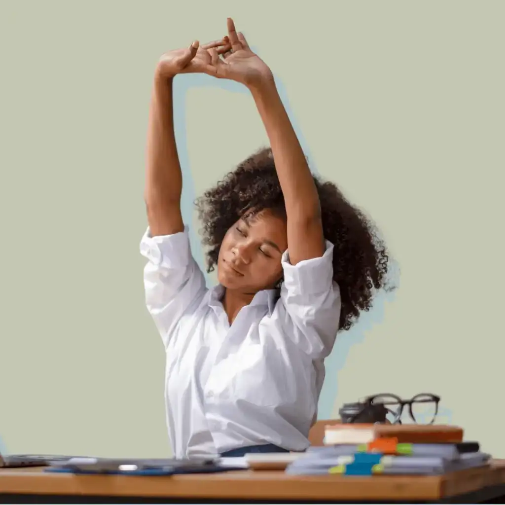 Self-Care Morning Rituals. Woman stretching her arms at a desk