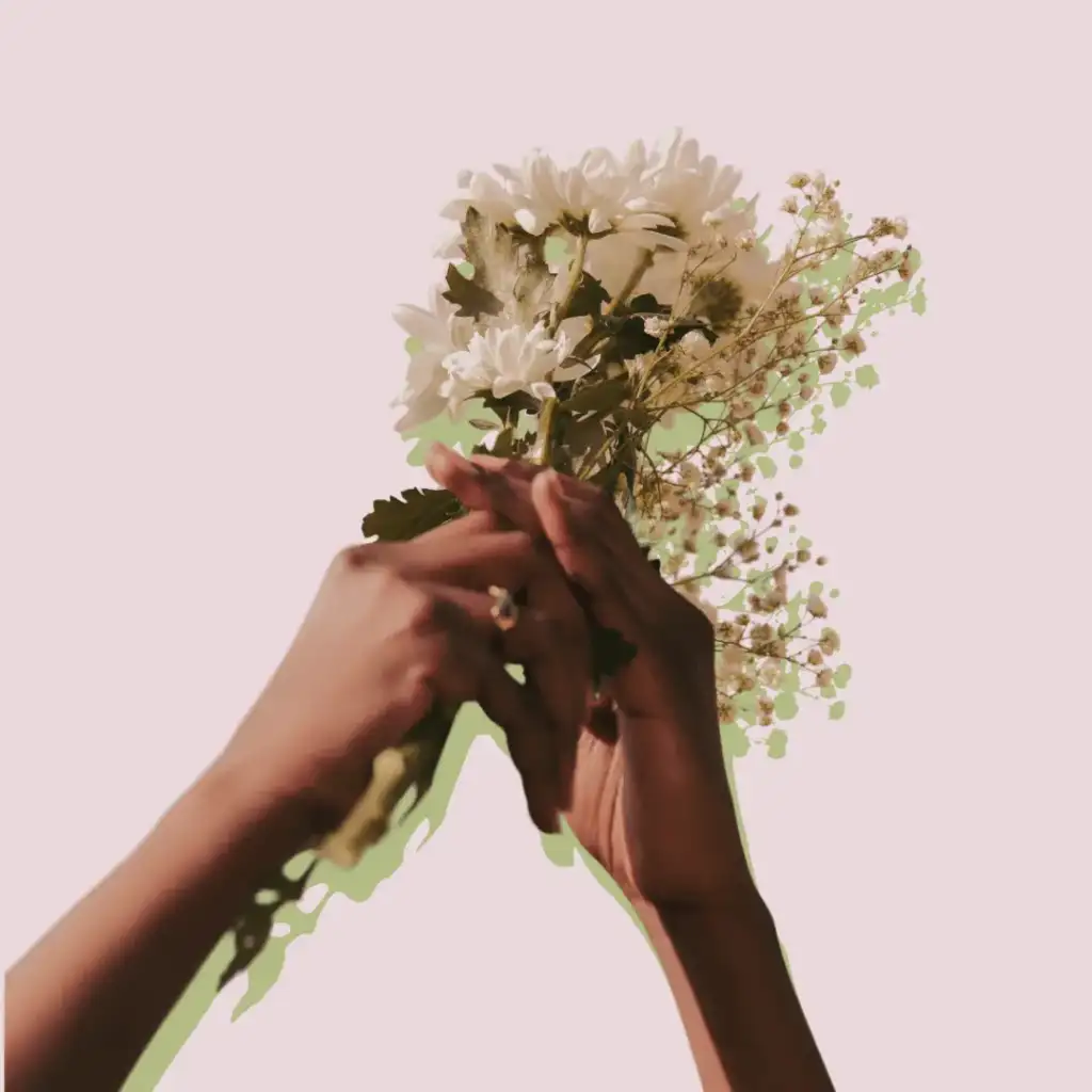 Woman hands holding a small bouquet of flowers.