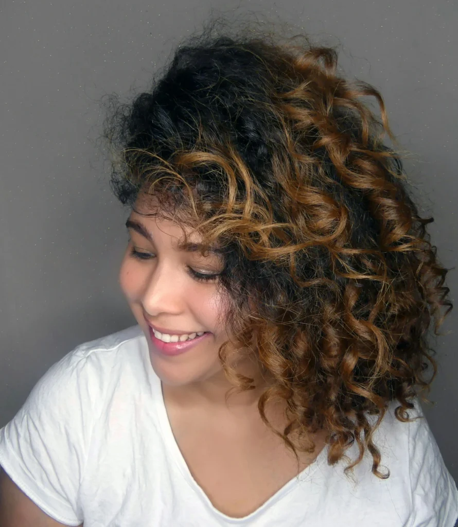 happy woman with curly hair. How To Treat Low Porosity Hair