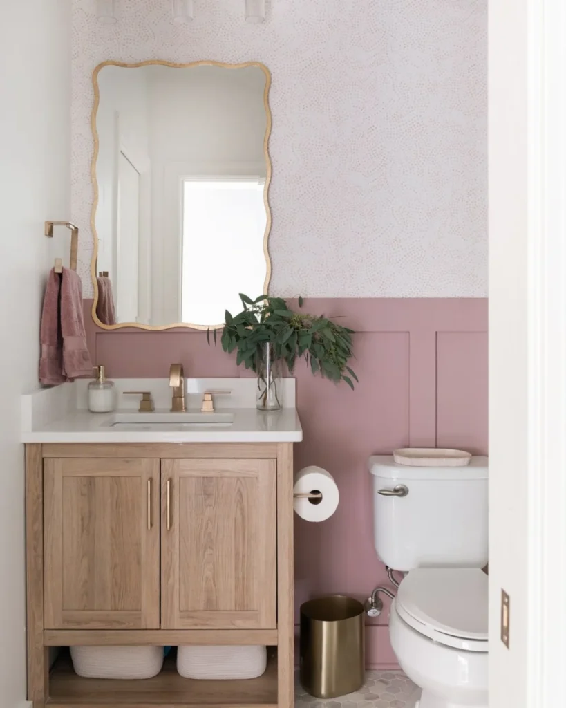 Pastel pink bathroom with darker pink wall panelling.