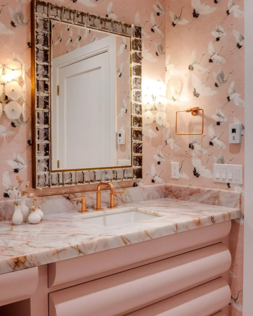 Pink bathroom with pink wallpaper with cranes. 