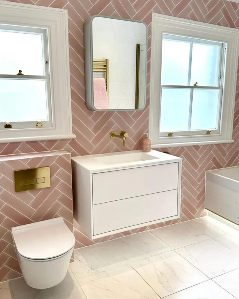 Herringbone tiled bathroom with white furniture