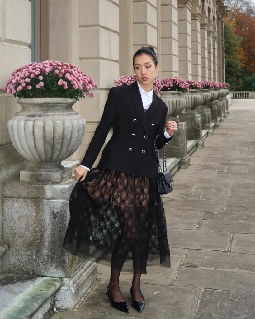 Woman wearing a black blazer and lace midi skirt. Old Money Outfit Ideas