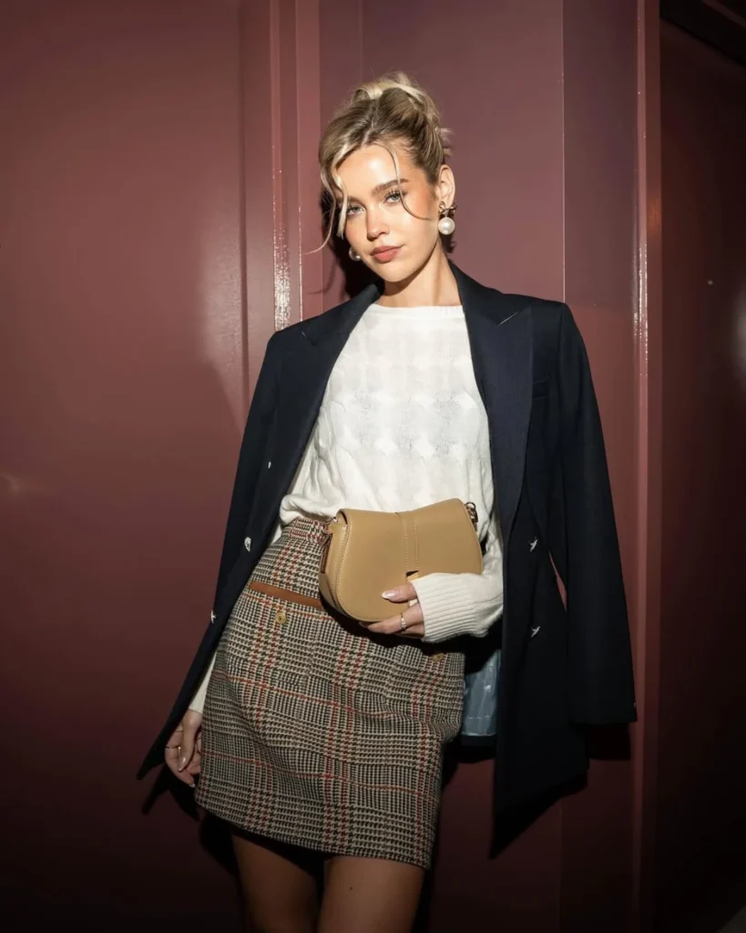 Young woman wearing a blazer, check skirt and brown bag. Old Money Outfit Ideas